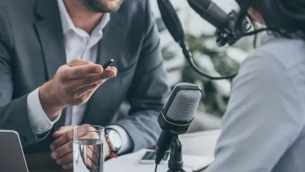 Podcast interview man and woman at microphone