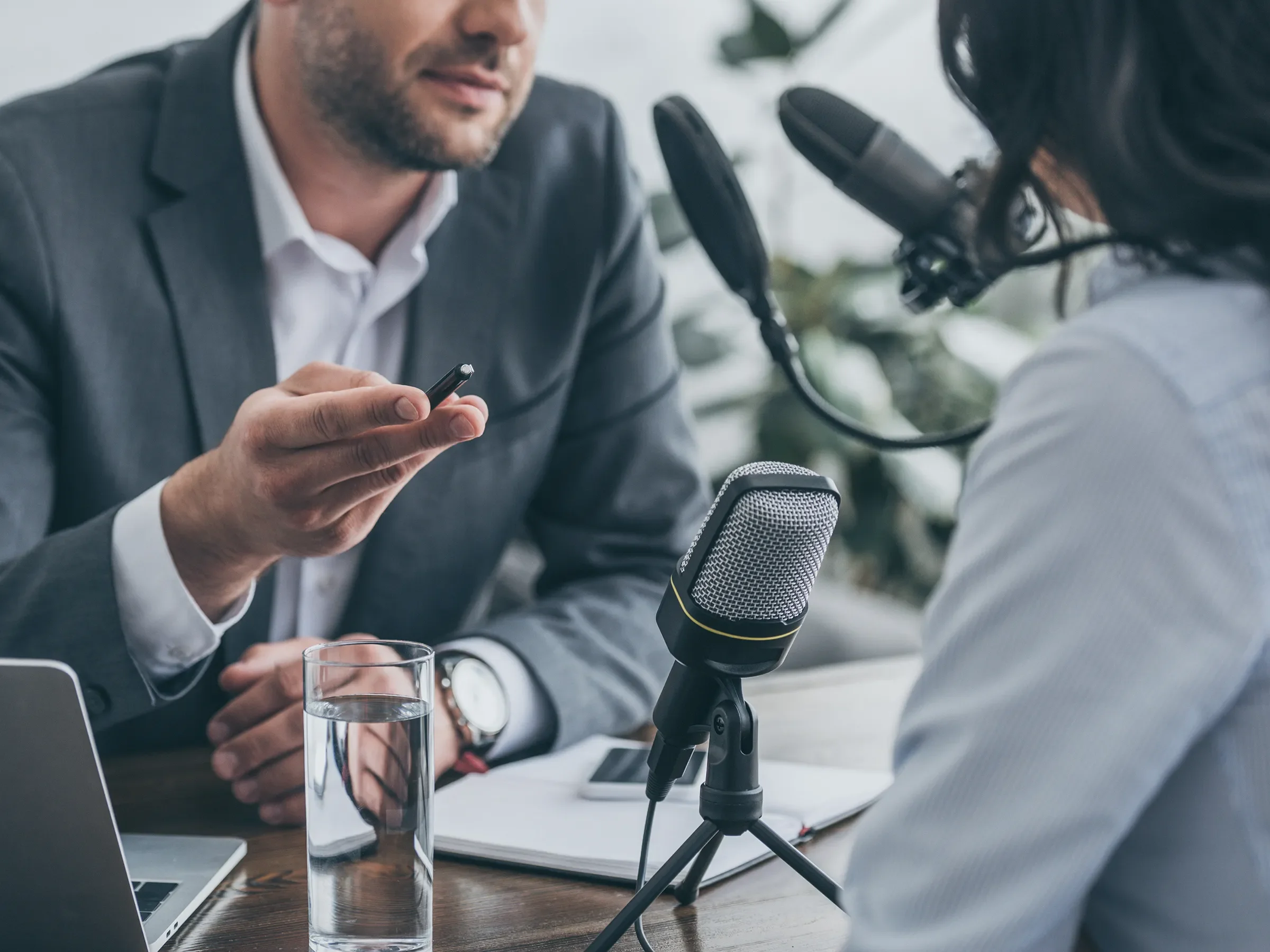 Podcast interview man and woman at microphone